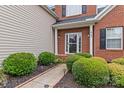 Inviting entryway with meticulously maintained landscaping and a charming walkway to the front door at 108 Planters Dr, Statesville, NC 28677
