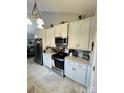 Modern kitchen features stainless steel appliances, including a refrigerator and range, with stylish tiled flooring at 111 Brookview Dr, Shelby, NC 28152