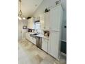 Modern kitchen features stainless steel appliances, including a dishwasher and sink, with stylish tiled flooring at 111 Brookview Dr, Shelby, NC 28152