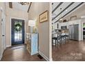 Inviting foyer leading to an open kitchen with stainless steel appliances and bar stool seating at 1111 Palmyra Dr, Fort Mill, SC 29708