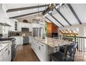 Spacious open-concept kitchen with a granite island, stainless steel appliances, and a unique beamed ceiling at 1111 Palmyra Dr, Fort Mill, SC 29708