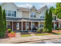 Inviting townhouse exterior with well-manicured landscaping and covered front porch at 11218 Grass Field Rd # 1083, Charlotte, NC 28213