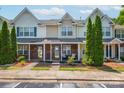 Attractive townhouse exterior with brick facade, covered porch, and mature trees at 11218 Grass Field Rd # 1083, Charlotte, NC 28213