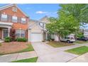 Charming townhouse with a well-manicured lawn, a driveway, and a one car garage at 11714 Harsworth Ln, Charlotte, NC 28277