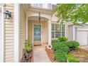 Inviting front entrance with a decorative door, plants, and well-maintained landscaping at 11714 Harsworth Ln, Charlotte, NC 28277