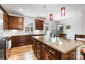 Spacious kitchen with a large island featuring granite countertops and ample storage space below at 1201 Township Pkwy, Belmont, NC 28012