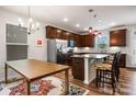 Warm kitchen with dark cabinets, stainless steel appliances, granite countertops, and pendant lighting at 1201 Township Pkwy, Belmont, NC 28012