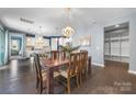 Open dining area with a wooden table, chandelier, and view into the spacious kitchen at 1284 Independence St, Fort Mill, SC 29708