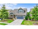 Beautiful two-story home with a well-kept lawn, flowering shrubs, and a two-car garage at 1284 Independence St, Fort Mill, SC 29708