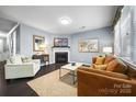Cozy living room with a fireplace, comfortable seating, and a bright window at 1284 Independence St, Fort Mill, SC 29708