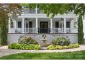 Charming entryway featuring a classic water fountain, vibrant flowerbeds, and a welcoming double door at 1600 Princeton Ave, Charlotte, NC 28209