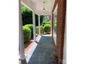 Covered front porch with brick facade, classic columns, and slate-look floor; great curb appeal at 1614 Statesville Blvd, Salisbury, NC 28144