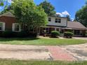 Charming two-story brick home with lush green lawn and mature trees at 1614 Statesville Blvd, Salisbury, NC 28144