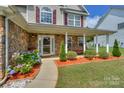 Beautiful home featuring a cozy front porch and lush hydrangea bushes at 166 Glenn Allen Rd, Mooresville, NC 28115