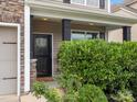 Charming front entrance is framed by stone accents and lush greenery, offering a warm and inviting welcome at 1810 Kerwick Ct, Lancaster, SC 29720