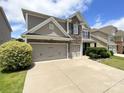 Charming two-story home with stone accents and a three-car garage, complemented by a well-manicured lawn and landscaping at 1810 Kerwick Ct, Lancaster, SC 29720