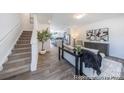 Bright living room boasts modern design, wood floors, and staircase leading to the second level at 205 Cliffwood Nw St # A-1, Concord, NC 28027