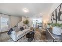 Open-concept living room featuring modern decor, wood floors, and ample natural light at 205 Cliffwood Nw St # A-1, Concord, NC 28027