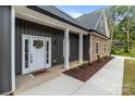Inviting front entrance with a decorated white door and modern exterior lighting at 209 Stafford Estates Dr, Salisbury, NC 28146