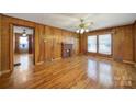 Inviting living room with hardwood floors, a charming brick fireplace, and ample natural light at 220 Parker Ave, Mooresville, NC 28115