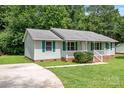 A charming single-story home with a cozy front porch and lovely green shutters at 2223 Pacer Rd, Lancaster, SC 29720