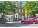 Beautiful brick townhome with lush trees, commercial space, and street parking at 2411 Bonterra Blvd, Indian Trail, NC 28079