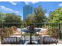 Relax on this cozy balcony with cityscape views, featuring an outdoor table and comfortable wicker chairs at 300 W Fifth St # 509, Charlotte, NC 28202