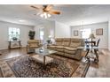 Bright living room featuring hardwood floors, a ceiling fan, and large windows at 3125 Leonard Dr, Gastonia, NC 28056