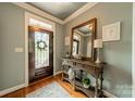The entryway features a decorative door, wooden floors, console table, and lovely decor at 3500 Maple Wood Dr, Denver, NC 28037