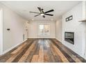 Spacious living room features a cozy fireplace, ceiling fan, and durable flooring at 3572 Heather Ln, Gastonia, NC 28056