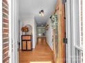 Entryway featuring hardwood floors, a cabinet, and a decorative front door at 4113 Edgeview Dr, Indian Trail, NC 28079