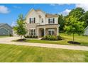 Charming home with stone accents, a welcoming porch, and a beautifully landscaped front yard at 433 Sinaloa St, Waxhaw, NC 28173
