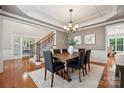 Dining room featuring hardwood floors, a modern chandelier, and access to other rooms at 5046 Cressingham Dr, Fort Mill, SC 29707