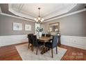 Cozy dining room with paneled walls, chandelier, and a large mirror at 5046 Cressingham Dr, Fort Mill, SC 29707