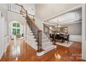 Elegant foyer with hardwood floors, staircase, and an adjacent dining room and living room at 5046 Cressingham Dr, Fort Mill, SC 29707