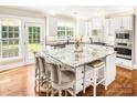 Bright, modern kitchen features white cabinets, granite countertops, a center island and stainless steel appliances at 5046 Cressingham Dr, Fort Mill, SC 29707
