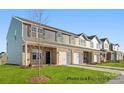 New townhomes showcase a mix of siding and brick, attached garages, and well-maintained lawns at 5142 Tommy Ln # 1202, Stanley, NC 28164