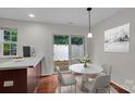 Charming dining area featuring a modern table, chairs, and access to the outdoor patio at 5237 Ficus Tree Ln, Charlotte, NC 28215