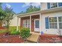 Charming front entrance with brick accents, a covered porch, and manicured landscaping at 5237 Ficus Tree Ln, Charlotte, NC 28215