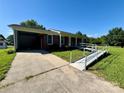 Accessible brick home features ramp, carport, and well maintained front lawn at 5420 Harkey Rd, Waxhaw, NC 28173