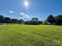 Bright view of the home featuring a meticulously maintained front lawn and accessible ramp at 5420 Harkey Rd, Waxhaw, NC 28173