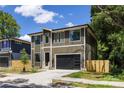 Well-manicured modern home featuring a two-car garage with sleek, contemporary lines at 550 W Cama St, Charlotte, NC 28217