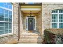 Charming front entrance with brick steps, decorative wreath, and inviting covered porch at 7006 Nesbit Rd, Waxhaw, NC 28173
