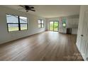 Inviting living space with light wood floors, sleek black windows, and sliding glass doors to the backyard at 760 3Rd Street Sw Pl, Hickory, NC 28602