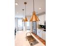 Bright kitchen with a large island, stainless steel appliances, quartz countertops, and pendant lighting at 8044 Cedarsmith Ct, Charlotte, NC 28217