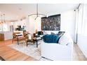 Open-concept living room with modern furniture, hardwood floors, and lots of natural light at 8044 Cedarsmith Ct, Charlotte, NC 28217