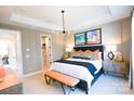 Stylishly decorated main bedroom with a king-sized bed, modern lighting, and decorative wall panels at 8044 Cedarsmith Ct, Charlotte, NC 28217