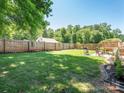 Large backyard with a patio, wooden deck, and privacy fence perfect for entertaining at 805 Brookmont Ave, Salisbury, NC 28146