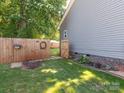 View of backyard with privacy fence and open gate to the rest of the yard at 805 Brookmont Ave, Salisbury, NC 28146