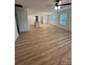Spacious living room with ceiling fan, wood flooring, and bright natural light at 807 S Bostian St, China Grove, NC 28023